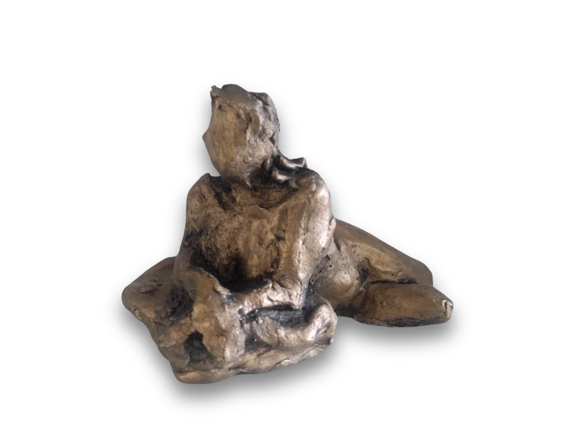 This sculpture is a study of the human form, capturing a reclining figure with an emphasized gesture. It is a beginner's piece in figure sculpture, sculpted in water-based clay, and measures approximately 9 inches in length. The work, showing a figure in a pose that suggests contemplation or rest, was created by Elizabeth Bonura.