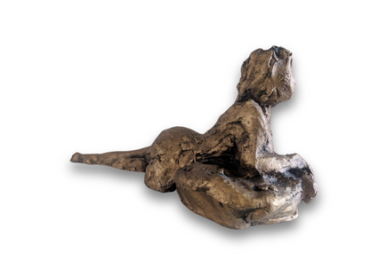This sculpture is a study of the human form, capturing a reclining figure with an emphasized gesture. It is a beginner's piece in figure sculpture, sculpted in water-based clay, and measures approximately 9 inches in length. The work, showing a figure in a pose that suggests contemplation or rest, was created by Elizabeth Bonura.